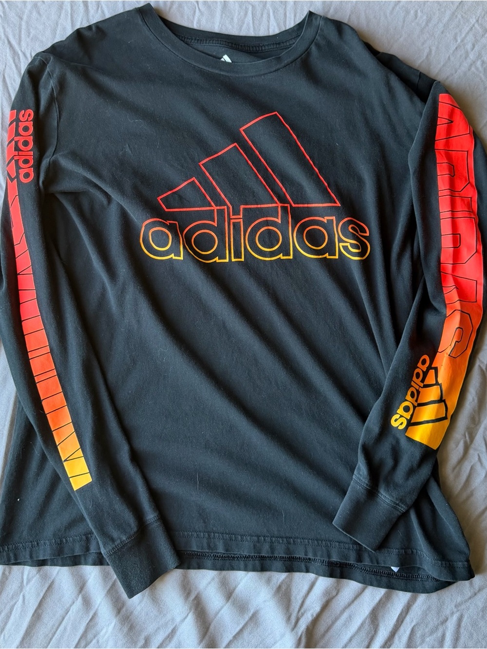 adidas Men’s Black Long-Sleeve Shirt with Red and Yellow Gradient Logo